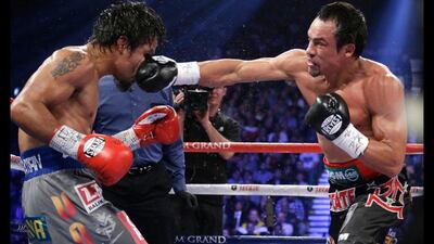 Juan Manuel Marquez, right, lands a right to the head of Manny Pacquiao during their WBO world welterweight. Julie Jacobson / AP Photo