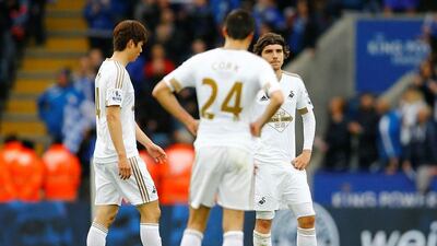 Swansea's Ki Sung Yueng and Alberto Paloschi look dejected. Reuters / Darren Staples