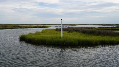 A cross rises from the marsh on Tangier Island in the Chesapeake Bay. Religion is an important part of life on Tangier. All photos: Willy Lowry / The National
