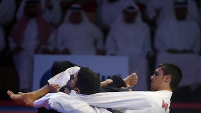 Omar Al Fadli, right, fights Hamad Mohamed Nawad, during their 55kg blue belt juvenile bout at the Abu Dhabi World Professional Jiu Jitsu Championship. Ravindranath K / The National