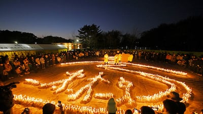 People gather around 6,434 candles to commemorate the victims of the Great Hanshin Earthquake, which struck Japan in January 1995. EPA