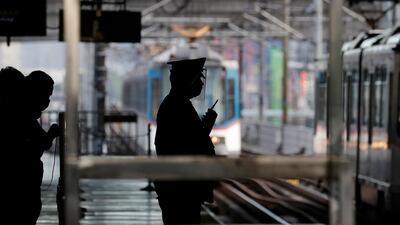 A security guard wears a protective shield as train stations open in Manila, Philippines. AP Photo