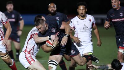A Dubai Exiles player attempts to break through the Abu Dhabi Harlequins defence.