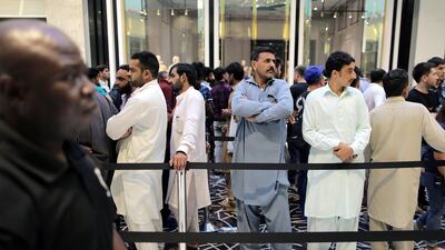 Customers queue outside the Apple store at Dubai Mall. Mahmoud Khaled / EPA