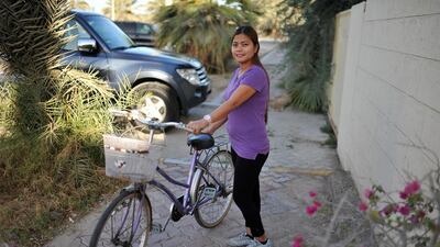 Emy Penid cycles to work every day from her home off Airport Road, staying off the main roads and using quiet neighborhood streets instead. She says the journey takes her about 15 minutes. Delores Johnson / The National