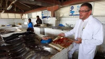 Sven Mostegl, a food consultant, points out issues of concern at the fish market in Sharjah.