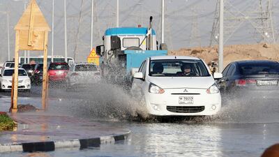 Water sprays up from a car in Dubai this morning. Pawan Singh / The National