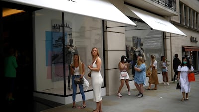 People are seen outside a Chanel store, as shops re-open amid the coronavirus outbreak, in New Bond Street in London, Britain June 15, 2020. REUTERS