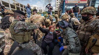 Lebanese army soldiers help supporters of Lebanese Christians parties to open the Northern Highway during a protest against the collapsing Lebanese pound currency and the price hikes of goods, in Al-Zouk area, northern Beirut, Lebanon. EPA