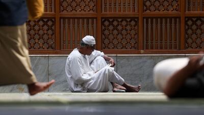 A worshipper reads the Quran at the Prophet's Mosque in Madinah. AFP