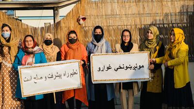 Pen Path campaigners hold placards in support of girls' right to education.