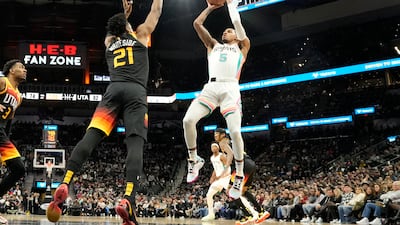 San Antonio Spurs guard Dejounte Murray (5) shoots over Utah Jazz centre Hassan Whiteside (21). Reuters