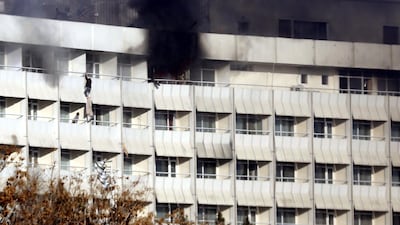 People use fabric to jump from the Intercontinental Hotel after an attack by armed gunmen in Kabul, Afghanistan. Jawad Jalali / EPA