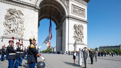 Sheikh Mohamed stands at attention as the national anthems of the UAE and France are played at the Arc de Triomphe. Photo: Presidential Court