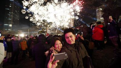 A couple takes a "selfie" as fireworks go off during a ceremony to celebrate the new year at Bongeun Buddhist temple in Seoul on January 1, 2015. Kim Hong-Ji/Reuters