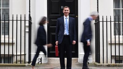 Britain's Chancellor of the Exchequer Jeremy Hunt posed with the red budget box as he left 11 Downing Street in London on Wednesday to present the annual budget. AFP