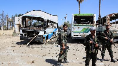 Regime soldiers stands guard in Syria's southwestern Quneitra province on July 2, 2017 during ongoing clashes for control of the city of Al Baath. AFP