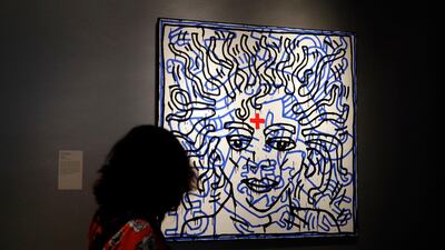 A woman looks at an artwork by Keith Haring called "Untitled" on display at "Michael Jackson: On the Wall" at the National Portrait Gallery in London, Britain, on June 27, 2018. Kirsty Wigglesworth / AP Photo