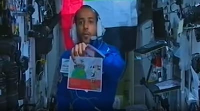 Maj Al Mansouri holds up Mishal's drawing on a live stream from the space station. Courtesy: Hazza Al Mansouri