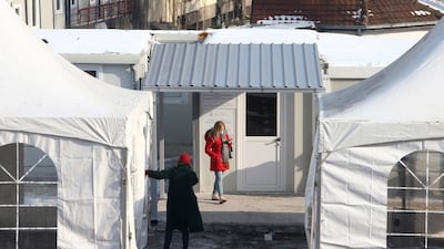 People wait to be inoculated on the first day of the vaccination campaign in Skopje, North Macedonia. AP