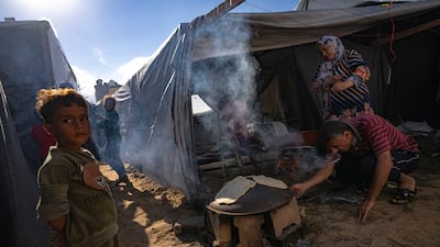 Palestinians displaced by the Israeli bombardment of the Gaza Strip prepare bread in a UN-run camp in Khan Younis. AP