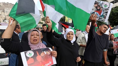 People shout slogans and wave flags during a protest in support of Palestinians, in the occupied West Bank. AFP