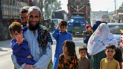 An Afghan refugee family living in Pakistan arrive at the UN High Commissioner for Refugees repatriation centre, near Peshawar. AFP