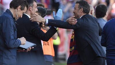 Barcelona coach Luis Enrique, right, celebrates his team's victory in the Spanish Liga after defeating 3-0 Granada at Nuevo Los Carmenes stadium in Granada, southern Spain, 14 May 2016. EPA/MIGUEL ANGEL MOLINA