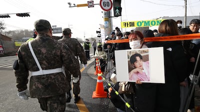 Fans wait in front of the boot camp as they hope to catch a glimpse of Jin. Getty