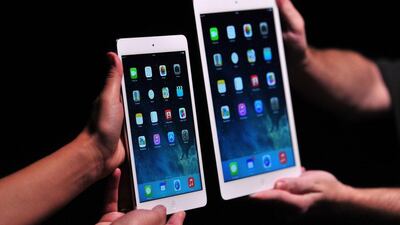 Apple employees show off the new iPad Air and iPad Mini at a satellite launch event in central London. Carl Court / AFP