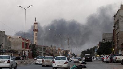 Smoke billows from buildings during clashes between Libyan security forces and armed Islamist groups in the eastern coastal city of Benghazi. Abdullah Doma / AFP