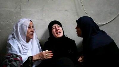 The wife of Palestinian Hamas member Ismail Al Tili mourns during his funeral in Beit Lahia, northern Gaza Strip.