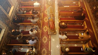 Worshippers attend Midnight Mass at the Church of St George in Cairo. Capacity at churches has been reduced due to the pandemic. AP Photo