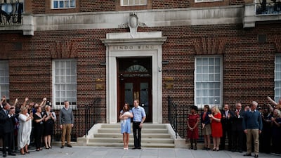 Britain's Prince William, centre right, and Kate, Duchess of Cambridge hold the Prince of Cambridge, Tuesday July 23, 2013, as they pose for photographers. AP Photo / Lefteris Pitarakis