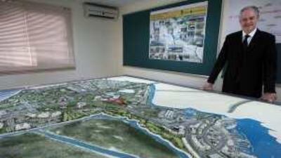 Richard Cregan, the CEO of Abu Dhabi Motorsport Management, at his office with a model of the Yas Island development.