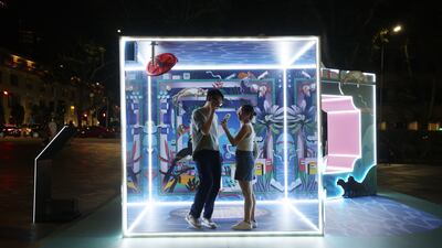 People interact with the art installation Two Sides of Our Island, during the opening of the Singapore Night Festival featuring more than 80 immersive experiences. EPA