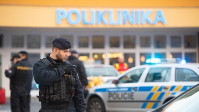 Police officers stand guard at the crime scene in front of a hospital in Ostrava, Czech Republic, where four people have been killed. EPA