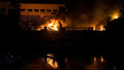 People extinguish a fire from a blast outside the National Cancer Institute, Cairo, Egypt. EPA