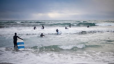 Novice surfers go surfing in the Norwegian Sea on March 12, 2017.