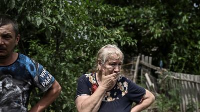 Lysychansk resident Yevgeniya Panicheva stands outside a house where two people were killed during shelling. The neighbouring city of Severodonetsk has been cut off from Lysychansk. AFP