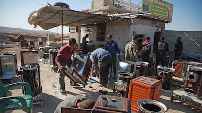 Syrians at a workshop building pistachio-powered heaters in Al Dana town in Syria's north-west province of Idlib . AFP