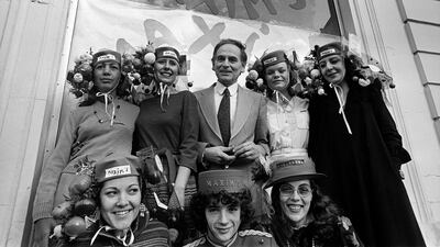 Pierre Cardin surrounded by 'Catherinette' in front of his new Parisian shop, Maxim's, in November 1977. AFP