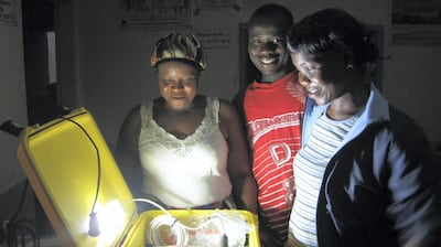 A Solar Suitcase, courtesy of We Care Solar, is opened at night in Liberia. Courtesy We Care Solar