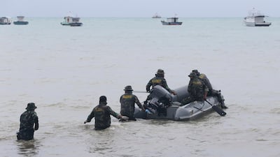 Marines search for victims at a beach in Sumur. AP Photo