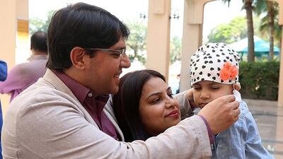 Subhash and Dimple Khamboj and their daughter Sahira attend the Childhood Cancer Day event at Dubai Hospital. Satish Kumar / The National