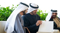 President Sheikh Mohamed shows Sheikh Mohammed, Vice President and Ruler of Dubai, his message in the photo album. Omar Al Askar / UAE Presidential Court