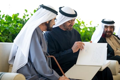 President Sheikh Mohamed shows Sheikh Mohammed, Vice President and Ruler of Dubai, his message in the photo album. Omar Al Askar / UAE Presidential Court