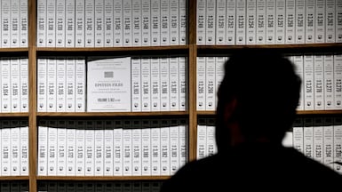 A visitor to a temporary exhibition called The Donald J Trump and Jeffrey Epstein Memorial Reading Room, in New York. It features bound print-outs of the files released by the US Department of Justice – about 3.5 million pages – relating to convicted sex criminal Epstein. AFP