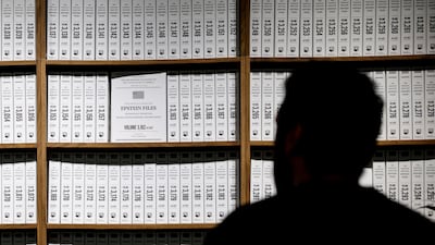 A visitor to a temporary exhibition called The Donald J Trump and Jeffrey Epstein Memorial Reading Room, in New York. It features bound print-outs of the files released by the US Department of Justice – about 3.5 million pages – relating to convicted sex criminal Epstein. AFP