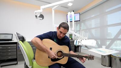 Dentist Tarek Al Khatib decided to learn to play guitar at the age of 41. Chris Whiteoak / The National